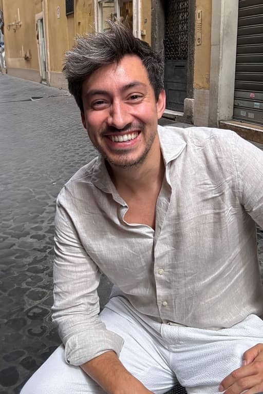 Input photo 2: the same man seated on a street in a linen shirt, the only full-body shot in the set