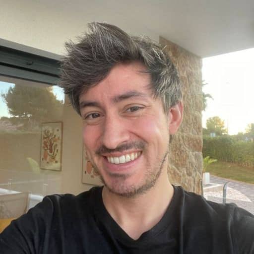 Input photo 3: selfie in the same living room, wide open smile, backlit by a window