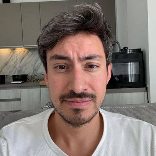 Input photo 5: selfie in a kitchen in a white t-shirt, neutral expression, no smile