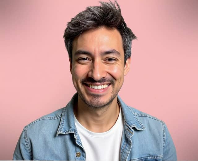 Man in a denim jacket on pink, with the warmest expression in the set